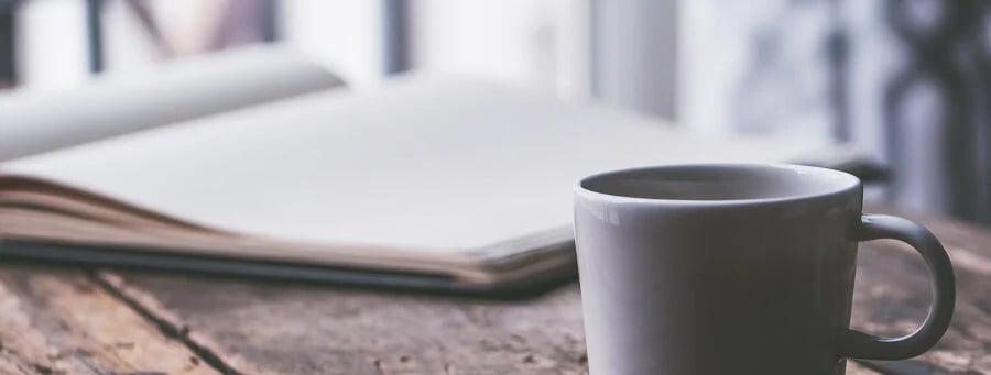 Laptop and coffee cup on a desk