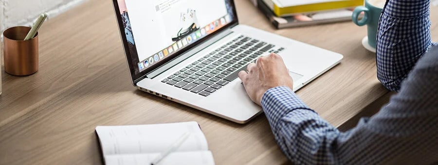 man at desk with laptop