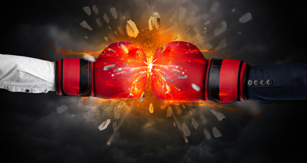two boxing gloves hitting together explosively
